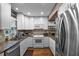 Modern kitchen featuring white cabinets, granite counters, and stainless steel appliances at 1339 Villa Ln # 50, Apopka, FL 32712