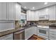 Bright kitchen with white cabinets, granite countertops, and stainless steel appliances at 1339 Villa Ln # 50, Apopka, FL 32712
