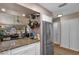 Eat-in kitchen boasts granite counters, stainless steel appliances, and a view to the living room at 1339 Villa Ln # 50, Apopka, FL 32712