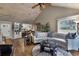 Open living room with vaulted ceiling, hardwood floors, and a view into the kitchen at 1339 Villa Ln # 50, Apopka, FL 32712