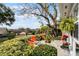 Relaxing patio area with orange chairs and greenery at 1339 Villa Ln # 50, Apopka, FL 32712