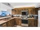 Galley kitchen with wood cabinets and appliances at 1420 N Atlantic Ave # 1501, Daytona Beach, FL 32118