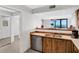 Kitchen with wood cabinets, appliances, and breakfast bar at 1420 N Atlantic Ave # 1501, Daytona Beach, FL 32118