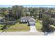 New construction home with driveway, and a large lot surrounded by trees at 1608 Airmont Ave, Deltona, FL 32725