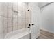 Clean bathroom with marble tile and a bathtub at 1608 Airmont Ave, Deltona, FL 32725