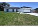 Charming single Gathering home with a crisp white exterior, black accents, and an attached two-car garage at 1608 Airmont Ave, Deltona, FL 32725