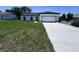 Well maintained single Gathering home with white exterior, black accents, paved drive, and manicured lawn at 1608 Airmont Ave, Deltona, FL 32725