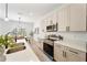 Modern kitchen with stainless steel appliances and light beige cabinets at 1608 Airmont Ave, Deltona, FL 32725
