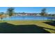 Spacious backyard with a pond view and homes in the background at 1706 Chatsworth Cir, Saint Cloud, FL 34771