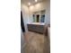 Double vanity bathroom with grey cabinets at 1706 Chatsworth Cir, Saint Cloud, FL 34771