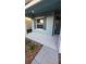 Inviting front porch with gray flooring and teal exterior at 1706 Chatsworth Cir, Saint Cloud, FL 34771
