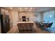 Modern kitchen with island, stainless steel appliances, and glass table at 1706 Chatsworth Cir, Saint Cloud, FL 34771