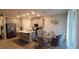 Modern kitchen with island, stainless steel appliances, and glass table at 1706 Chatsworth Cir, Saint Cloud, FL 34771