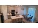 Modern kitchen with island, stainless steel appliances, and glass table at 1706 Chatsworth Cir, Saint Cloud, FL 34771