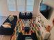 Spacious living room with sectional sofa, large TV, and patterned rug at 1706 Chatsworth Cir, Saint Cloud, FL 34771