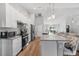 Modern kitchen with an island, white cabinets, and stainless steel appliances at 1780 Sw 168Th Loop, Ocala, FL 34473