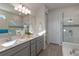Elegant bathroom with double vanity, soaking tub, and walk-in shower at 1914 Summer Serenity Dr, Kissimmee, FL 34744