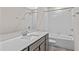 Modern bathroom with a tub, shower, vanity, and white tile at 1914 Summer Serenity Dr, Kissimmee, FL 34744