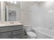 Clean bathroom featuring a bathtub, toilet and vanity with grey cabinets at 1914 Summer Serenity Dr, Kissimmee, FL 34744