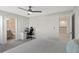 Spacious bedroom with carpeted floor, built-in desk, and access to a bathroom at 1914 Summer Serenity Dr, Kissimmee, FL 34744