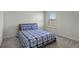Well-lit bedroom featuring a double bed and carpet flooring at 1914 Summer Serenity Dr, Kissimmee, FL 34744