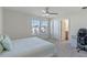 Main bedroom with large bed, ceiling fan, and en-suite bath at 1914 Summer Serenity Dr, Kissimmee, FL 34744