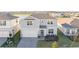 Two-story house with gray siding, white garage door, and landscaped yard at 1914 Summer Serenity Dr, Kissimmee, FL 34744