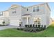 Charming two-story home with a two-car garage, manicured lawn, and stone accents in a sunny neighborhood at 1914 Summer Serenity Dr, Kissimmee, FL 34744