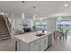 Open concept kitchen with island, stainless steel appliances, and views to the living room at 1914 Summer Serenity Dr, Kissimmee, FL 34744