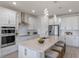 Modern kitchen boasts white cabinets, quartz countertops, and stainless steel appliances at 1914 Summer Serenity Dr, Kissimmee, FL 34744