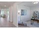 Home office with hardwood floors, built-in shelving, and a comfortable seating area at 1914 Summer Serenity Dr, Kissimmee, FL 34744