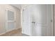 Hallway with neutral carpeting, a door, and built-in closet at 1964 Tamarack Pass, Davenport, FL 33837