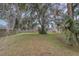 Spacious backyard with grassy area, large tree, and privacy fence at 216 Blue Crystal Dr, Deland, FL 32720