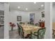 Formal dining room with a large table and green chairs, view into kitchen at 216 Blue Crystal Dr, Deland, FL 32720