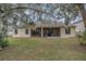 Back of house showing screened porch and backyard at 216 Blue Crystal Dr, Deland, FL 32720