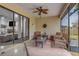 Relaxing screened porch with wicker furniture and ceiling fan at 216 Blue Crystal Dr, Deland, FL 32720