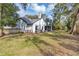 Large backyard with a grassy area and screened porch at 2376 Park Village Pl, Apopka, FL 32712