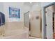 Bathroom featuring a bathtub, separate shower with a glass door, and a stained glass window at 2376 Park Village Pl, Apopka, FL 32712