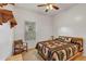 Cozy bedroom with a rustic-style bed and chair at 2376 Park Village Pl, Apopka, FL 32712