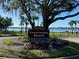 Sweetwater Beach community sign near the lake. Palm trees and beautiful landscaping surround the sign at 2376 Park Village Pl, Apopka, FL 32712