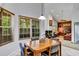 Eat-in kitchen dining area with a wood table set, bright windows, and tile flooring at 2376 Park Village Pl, Apopka, FL 32712