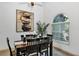 Cozy dining room featuring a wood table set, modern art, and natural light from the window at 2376 Park Village Pl, Apopka, FL 32712