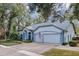 House exterior showcasing a two-car garage and manicured lawn at 2376 Park Village Pl, Apopka, FL 32712