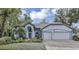 Two-story house with a two car garage and landscaped front yard at 2376 Park Village Pl, Apopka, FL 32712