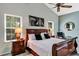 Comfortable main bedroom featuring a ceiling fan, two side tables, and tranquil natural light at 2376 Park Village Pl, Apopka, FL 32712