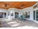 Outdoor patio featuring ceiling fans, sliding glass doors, and a seating area, perfect for entertaining or relaxing at 2376 Park Village Pl, Apopka, FL 32712