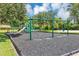 playground with swings and climbing structures at 2376 Park Village Pl, Apopka, FL 32712