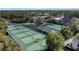 Community tennis courts with surrounding trees at 2376 Park Village Pl, Apopka, FL 32712