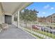 Relaxing balcony with seating, overlooking a tree-lined street at 239 Longview Ave # 216, Celebration, FL 34747