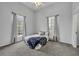 Cozy bedroom with a plush blanket and plenty of natural light at 239 Longview Ave # 216, Celebration, FL 34747